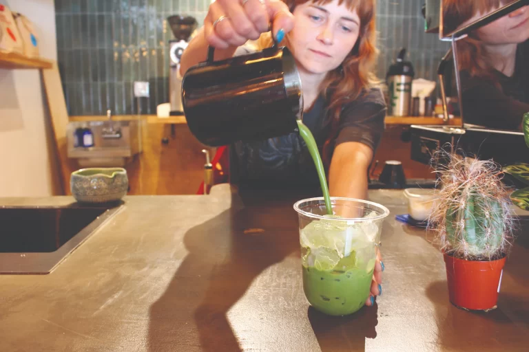 Moon Wolf Provisions manager pouring matcha over ice behind the bar